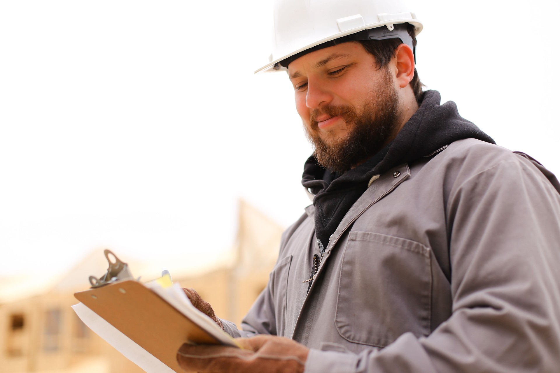 Portrait of architect drawing plan in notebook at construction site